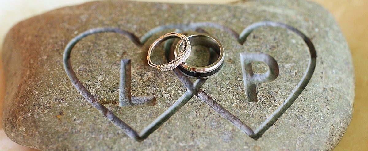 wishing or oathing stone with wedding rings on top
