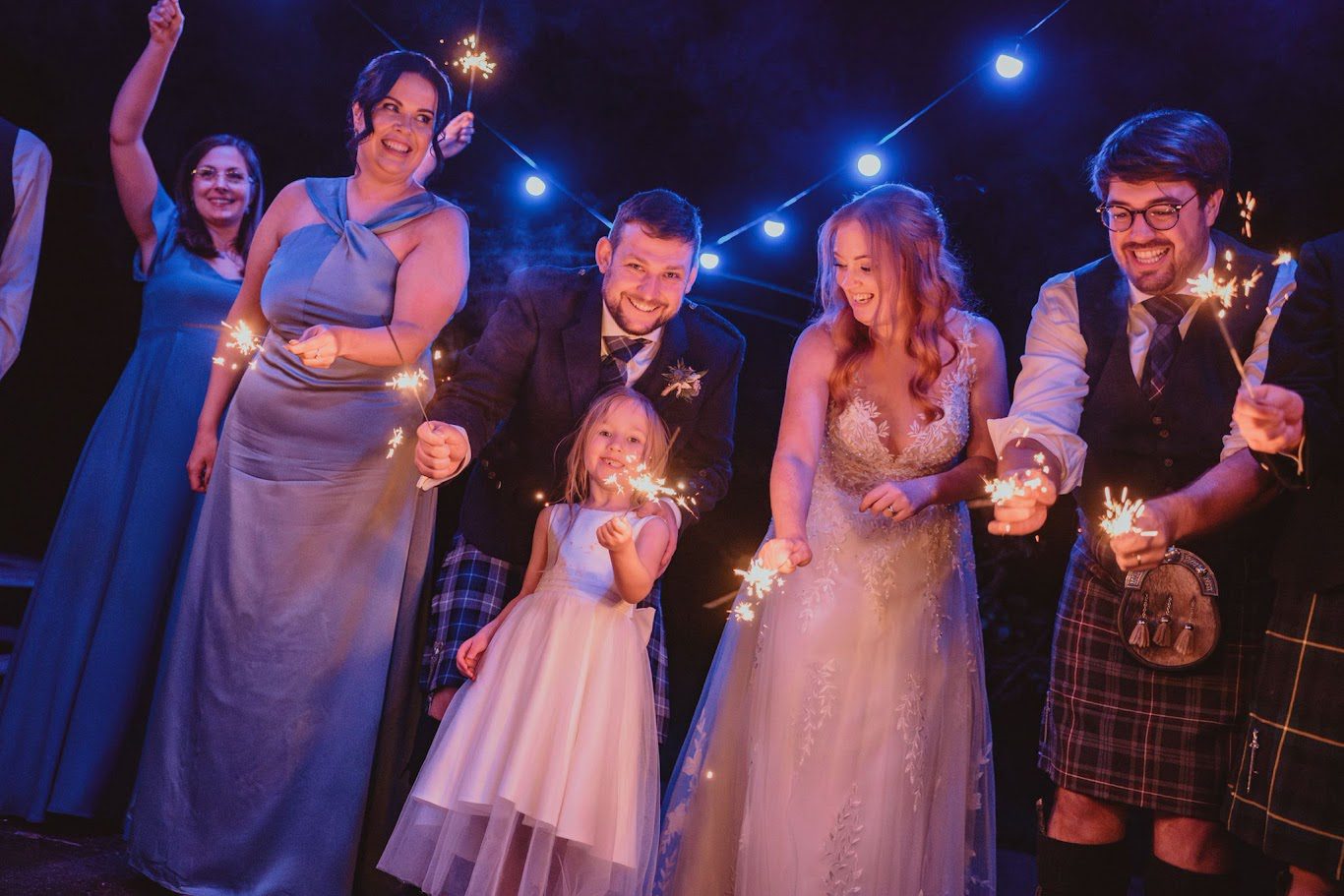 a photo of martin and leanne and their family with sparklers on their wedding day